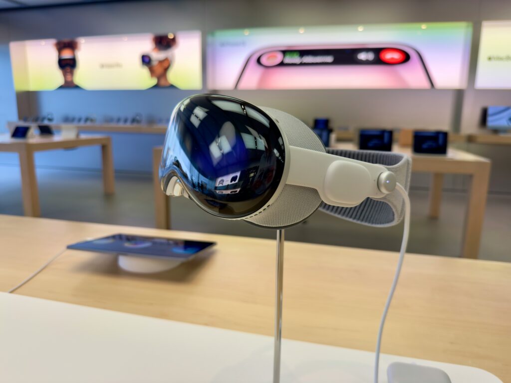 medium close up of vision pro device on its custom stand, in an apple retail store. 